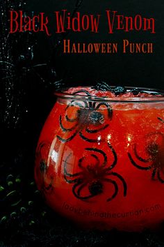 an orange vase with black decorations on it and some plants in the background, along with text that reads black widow venom halloween punch