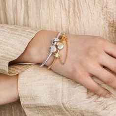 Bring some sparkle to every moment with the Pandora Moments Sparkling Crown O Snake Chain Bracelet. Hand-finished in 14k gold plating the bracelet's clasp features the iconic Pandora crown O monogram and sparkling clear cubic zirconia pavé, while the snake chain brings a chic and modern touch to your wrist. Stack it with other bracelets and load it up with favourite charms for a piece you'll reach for over and over. - Pandora Moments Sparkling Crown O Snake Chain Bracelet - 14k Gold-plated unique metal blend / Cubic Zirconia / Clear - Sz. 7.9 in Silver Gold-plated Bangle Charm Bracelet, Silver Gold Plated Bangle Charm Bracelet, Gold Charm Bracelet With Cubic Zirconia, Gold Cubic Zirconia Charms Bracelets, Gold Cubic Zirconia Bracelet With Charms, Silver Gold Bracelet With Adjustable Cubic Zirconia Chain, Anniversary Silver Gold-plated Chain Bracelet, Elegant Metal Charm Bracelet With Snake Chain, Luxury Jewelry With Charms On Snake Chain