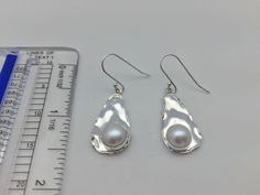 Hi everyone, just wanted to let you know we are open and shipping daily. Beautifully crafted handmade pearl and sterling silver dangle earrings. Features perfectly matched hand picked South Sea Pearls in a stunning silver setting so unique you will not go unnoticed. This line of pearl jewelry makes excellent brides made gifts and has been a top seller in our San Francisco jewelry store for years. Sterling Silver Teardrop Pearl Earrings For Everyday, Silver Teardrop Pearl Earrings For Everyday, Everyday Sterling Silver Teardrop Pearl Earrings, Nickel-free Teardrop Pearl Earrings In Sterling Silver, Silver Teardrop Pearl Earrings With Ear Wire, Sterling Silver Pear Shaped Pearl Earrings, Everyday Silver Sterling Pearl Earrings, Everyday Silver Sterling Silver Pearl Earrings, Everyday Pear-shaped Silver Jewelry