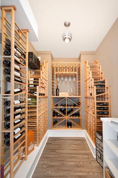 a wine cellar with wooden shelves filled with bottles