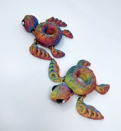 two colorful sea creatures sitting on top of a white table