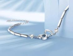 This beautiful Double Heart Bracelet is the perfect way to show your loved one how much you care. Made from Sterling Silver, this bracelet features two hearts intertwined with each other, symbolizing the strength of your love. Cubic Zirconia stones add a touch of sparkle and glamour, making this bracelet the perfect gift for that special someone in your life. Couples' Stainless Steel Heart Jewelry, Couples' Stainless Steel Heart-shaped Jewelry, Couples' Heart Shaped Stainless Steel Jewelry, Elegant Bracelets With Heart Charm For Promise, Elegant Adjustable Stainless Steel Heart Bracelet, Elegant Promise Bracelets With Heart Charm, Elegant Stainless Steel Heart Bracelet For Anniversary, Minimalist Heart-shaped Promise Bracelets, Elegant Adjustable Hypoallergenic Heart Bracelet