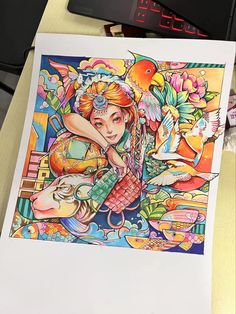 a drawing of a woman with birds and flowers on her head sitting in front of a computer keyboard