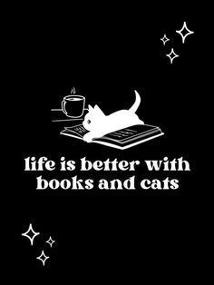 a white cat sitting on top of a book next to a coffee cup and stars