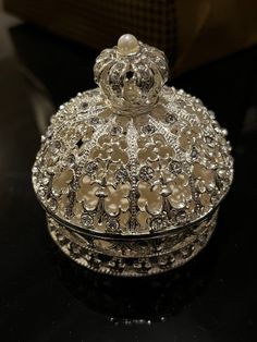 an ornate silver box sitting on top of a table