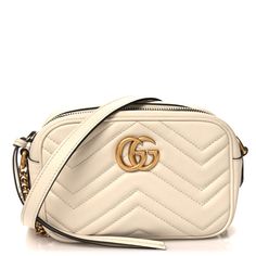 This is an authentic GUCCI Calfskin Matelasse Mini GG Marmont Chain Shoulder Bag in White. This shoulder bagis crafted of chevron-quilted calfskin leather in white. The bag features an aged gold chainand leather shoulder strap, and a matching gold Gucci GG logo on the front. The tasseled top zipper opens the bag to a nude beige microfiber interior with a patch pocket. Gg Logo, Gg Marmont, Chain Shoulder Bag, White Bag, Patch Pocket, Calf Skin, Shoulder Strap, Gucci, Shoulder Bag