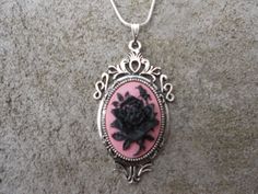 "For sale are beautiful flawless (black rose with a single bud on a pink background) cameo pendant necklaces They are offered at a reasonable price, make perfect gifts, and are wonderful quality The cameo is set in a gorgeous ornate tibetan silver setting, and the chain is 22\" .925 silver plated 1.2mm snake chain, with a lobster claw clasp I make several varieties, colors, styles and matching sets I will be glad to do special requests or matching pendant, cuff bracelet and/or brooch if you don' Rose-colored Gothic Jewelry For Gift, Gothic Rose Jewelry For Gift, Gothic Rose Colored Jewelry For Gift, Gothic Rose-colored Jewelry For Gifts, Rose Oval Jewelry With Rose Design, Oval Rose Jewelry With Rose Design, Black Cameo Jewelry For Gifts, Black Cameo Jewelry As A Gift, Pink Cameo Necklace For Gifts