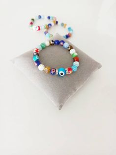 ⭐️The millefiori beads on the stretch bracelets are made of glass. ⭐️These Italian Floral beaded bracelets include multicolored Millefiori beads with glass evil eye. ⭐️This Millefiori Stretch Bracelet with Evil eye charm would be the perfect gift as a protection amulet. For more evil eye bracelets, click the link below; https://www.etsy.com/shop/EyeDesignsbyGG?ref=search_shop_redirect&section_id=30219689 Multicolor 8mm Beads Wristband For Gift, Multicolor 8mm Bead Wristband Gift, Multicolor Beaded Bracelets With Evil Eye, Multicolor Beaded Evil Eye Bracelet Spiritual, Multicolor Beaded Evil Eye Bracelet, Multicolor 8mm Beads Stretch Bracelet As Gift, Multicolor Round Beads Wristband For Gift, Adjustable Multicolor Evil Eye Beads, Multicolor Stretch Bracelet With Round Beads As Gift