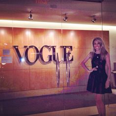 a woman standing in front of a sign that says vocie