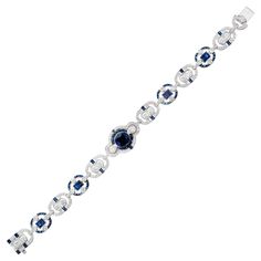 Absolutely stunning GIA Certified sapphire and diamond bracelet. This bracelet begins with a GIA certified, simple heat only, 2.00ct oval sapphire at the center and is accented by halos of baguette sapphires and round diamonds. A staggering 330 stones adorn this Art Deco style 18k white gold bracelet. It measures at 7.25 in length. There is a built in catch with and underside safety. The design and craftsmanship is simply spectacular. 1 oval blue sapphire, approx. 2.00cts GIA Certificate #623407 Luxury Sapphire Diamond Round Bracelet, Luxury Sapphire Diamond Bracelet, Classic Round Sapphire Diamond Bracelet, Luxury Round Sapphire Bracelet, Luxury Sapphire Bracelets, Formal Sapphire Round Bracelets, Formal Round Sapphire Bracelet, Luxury Oval Sapphire Tennis Bracelet, Luxury Formal Bracelet With Halo Setting