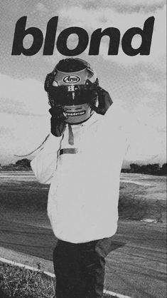 a black and white photo of a man holding his head in front of the camera