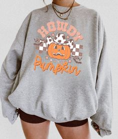 Halloween sweatshirt that will make you cozy during the spookiest time of the year! The perfect sweatshirt to cuddle up in at home, or super stylish to wear out to show your holiday spirit! PRODUCT INFORMATION * High-quality materials for the perfect cozy hoodie * Direct-to-garment printing, No cracking! * This sweatshirt runs true to size for a perfect unisex fit, please check size chart * The fabric is made from 50% cotton and 50% polyester * True to size sweatshirts, please size up for an ove Oversized Halloween Hoodie With Letter Print, Oversized Hoodie With Letter Print For Halloween, Oversized Trendy Halloween Hoodie, Trendy Oversized Halloween Hoodie, Trendy Graphic Print Halloween Hoodie, Trendy Oversized Hoodie For Halloween, Trendy Long Sleeve Halloween Hoodie, Trendy Graphic Print Sweatshirt For Fall, Spooky Long Sleeve Sweatshirt For Fall