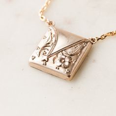 This one-of-a-kind necklace is composed of: Victorian men's cufflink with floral embossed details from the late 1800s. This necklace measures a standard 18” on a modern 14k gold filled chain, with the pendant measuring 0.75" in width. Victorian Man, Floral Pendant, Signature Jewelry, Charm Rings, Cufflinks Men, Victorian Jewelry, Gold Filled Chain, Antique Rings, Ring Necklace