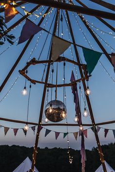 the inside of a tent with lights hanging from it