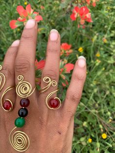 Gold wire adjustable Curl ring with Red Crystal. (Ring pictured on Ring finger) Adjustable Red Metal Rings, Adjustable Red Bohemian Jewelry, Bohemian Adjustable Red Jewelry, Adjustable Bohemian Red Jewelry, Red Adjustable Wire Wrapped Rings, Adjustable Red Wire Wrapped Rings, Red Hand Wrapped Jewelry Gift, Hand Wrapped Red Jewelry For Gift, Adjustable Wire Wrapped Metal Ring