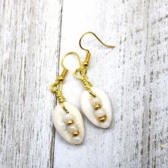 Simple, yet so beautiful for all things summer. These earrings are as easy breezy as your beach days. Incredibly lightweight, but still make a huge statement. #earrings #shell #beachwear #cowrieshell cowrie #summer #healing #ocean #jewellery #mermaid #bohostyle #style #nature #seashell #turquoise #beach #design #everyday #fossil #fashion #accessories #beautiful #fashionista #bohemian #bohochic #gypsy #breezy #bohemianstyle #freespirit #jewelry Handmade Summer Jewelry For Beach Wedding, Bohemian White Earrings For Beach, White Jewelry For Summer Beach Wedding, Gold Ocean-inspired Beach Earrings, White Jewelry For Beach Wedding In Summer, White Jewelry For A Beach Wedding In Summer, White Ear Wire Earrings For Vacation, White Earrings With Ear Wire For Vacation, White Dangle Earrings For The Beach