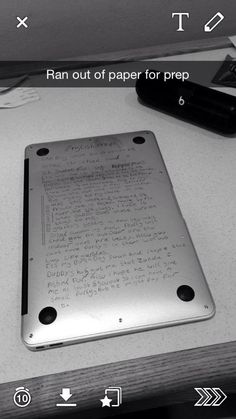 a tablet with writing on it sitting on a desk