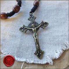 Look at this lovely Ave Maria pocket Rosary. The oval beads are a comfortable size and stained and varnished in a rich brown color. This is not really styled as a bracelet but the Hail Mary decade loop is approximately 8.5 inches around. It is a nice size for your pocket, bag, or car. The center medal and crucifix are made of antique bronzed finish alloy. The crucifix is 2" tall and the center medal is 1". Note that we cannot resize this rosary. Thank you for shopping and God Bless! Cordbands LL Beaded Brown Rosary Gift, Brown Beaded Rosary As Gift, Brown Beaded Rosary Gift, Adjustable Brown Wooden Beads Rosary, Adjustable Brown Wooden Bead Rosary, Spiritual Brown Rosary Bracelet With Cross, Handmade Brown Spiritual Rosary, Adjustable Brown Wooden Rosary, Adjustable Brown Spiritual Rosary