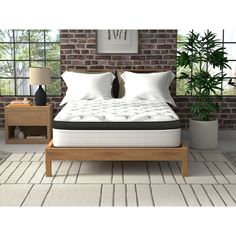 an image of a bed in the middle of a room with brick wall and windows