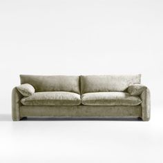 a beige couch sitting on top of a white floor