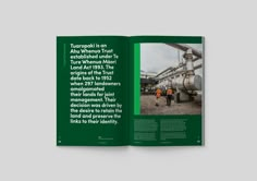 the book is open to show an image of people in front of pipes and tanks