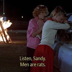 two women leaning against the back of a car in front of a fire with text that reads listen, sandy men are rats