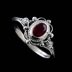 Victorian Oval Ruby Diamond Twisted Swirl Design Open Filigree 14K White Gold Bezel Set Engagement Ring Stunning, romantic Victorian style engagement ring made of 14K white gold. Features a bezel set oval ruby (~1/2ct) and two small diamonds (.06cttw, G-SI1 quality). Stones are enveloped in intricate open filigree and twisted wire design giving the ring the vintage luscious feel. Sizes: 4-8 (smaller and larger sizes are available as custom orders.) PROUDLY MADE FROM SCRATCH IN NEW YORK CITY. Ple Oval Ruby Engagement Ring, Victorian Engagement Rings, Ruby Engagement Ring, 925 Silver Jewelry, Jewelry Wedding, Gull, 925 Jewelry, Ring Vintage, Styl Vintage