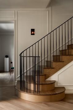 the stairs in this house are made of wood and wrought iron, with two lights on each side