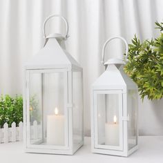 two white lanterns sitting next to each other