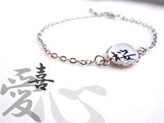 Japanese Bracelet with a Kanji of your choice in silver color - Black text on White background - Tray dia approx. 1/2 in / 12.7mm Extender chain 2 in / 5cm non-water resistant select [ 1 ] Select a Kanji from 24. [ 2 ] Size (your wrist size) Other size? Ask me before purchasing. * Non-water resistant. Tracking number The shipping cost does not include a tracking number. Add this if you need : www.etsy.com/listing/177273933 Please read Shop Policies before purchasing. ありがとう (Arigatoh/ Thanks) for Silver Name Bracelet With Adjustable Chain, Gift, Customized Minimalist Silver Bracelets, White Engraved Round Bracelets, Adjustable White Round Chain Bracelet, Personalized Symbolic Silver Bracelets, Customizable Silver Spiritual Bracelets, White Adjustable Engraved Bracelets, White Engraved Adjustable Bracelet, Adjustable Engraved White Bracelets