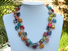 "3 Strand Necklace, Murano Glass, \"Exposed Gold\" Venetian Beads, Small Flat Squares with 24 Karat Gold Foil, Multicolored Lampworked Beads; handmade beads from Venice, Italy. This outstanding triple strand necklace is shown here in a vivid display. A beautiful necklace to go with every color in your wardrobe! The colorful, Venetian glass beads are handcrafted in such a way, as to show, or \"Expose\" the 24 karat gold foil. That is why I originated the term, \"Exposed Gold\" when referring to t Multicolor Murano Glass Spacer Beads, Multicolor Murano Glass Necklace With Spacer Beads, Polished Multicolor Murano Glass Beads, Multicolor Murano Glass Beaded Necklace, Elegant Multicolor Beaded Necklaces With Spacer Beads, Elegant Multicolor Czech Glass Beads, Multicolor Murano Glass Necklace With Polished Beads, Elegant Multicolor Large Beads Gems And Cabochons, Elegant Multicolor Czech Glass Necklaces