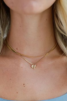 Finish off your elegant evening look with the Skylar Gold Bow Charm Layered Snake Chain Necklace! This trendy necklace features two layers of gold snake chains with a bow charm on the end. Style the Skylar Necklace with any outfit to instantly upgrade your look! Gold Plated Layered Snake Chain Bow Charm Lobster Clasp with Extender Layer 1 | Length 7" Layer 2 | Length 6" Extender | Length 3" Sneaker Heels Wedges, Gold Snake Chain, 7 Layer, Trendy Necklace, Snake Chain Necklace, Bow Jewelry, Rust Dress, Espresso Martini, Trendy Necklaces