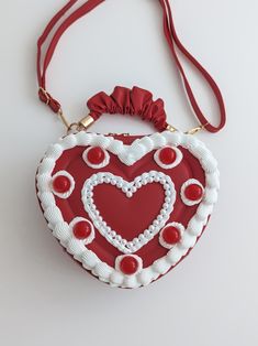 Introducing the FROSTED SWEETHEART CAKE BAG from our Valentine Collection - a delightful creation inspired by vintage cakes. (Details) Shape: Heart Base material : PU leather  Closure : Zipper  Strap : Adjustable long strap  Heart shape size: About 8.5 inches wide, about 7 inches in length, and about 2.5 inches in height. Color: Red bag with white icing Protection: Sealed for a lovely finish and added durability. Our sweetheart bags are water-resistant and pleasant to the touch. Delivery: Carefully wrapped and securely boxed for flawless delivery. (Care Instructions) Gentle Maintenance: The item gathers dust over time. Use a soft brush gently to brush away the dust. Please avoid using any liquids for cleaning. Instagram : @prettilyli Candy Themed Bedroom, Valentine Collection, Vintage Cakes, Cake Bag, Fashion Moodboard, Cherry Cake, White Icing, Red Bag, Heart Cake