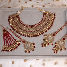 Antique gold polished necklace set made up of champagne zircon crystals and maroon bead drops.  Necklace (2 inch width) comes complete with matching large tikka,, jhumar and earrings measuring 2.5 inch in length x 1.5 inch width. Necklace is adjustable to fit any size and measures 2.5 inch width.  Ready to ship as seen with gift box. Drops Necklace, Bridal Jewelry Sets Brides, Bridal Jewellery Inspiration, Pakistani Bridal Jewelry, Bride Jewelry Set, Wedding Necklace Set, Indian Bridal Jewelry Sets, Fancy Jewellery Designs, Asian Jewelry