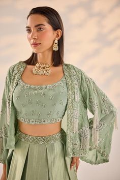 Sage green can can attached box-pleated lehenga embellished by pearl sequin geometric patterned waistband. Comes with pearl-sequin embellished floral-geometric motif cape. Paired with padded embellished blouse. - Aza Fashions Elegant Embellished Pista Green Set, Elegant Green Sets With Pearl Embroidery, Elegant Pista Green Choli With Mirror Work, Elegant Semi-stitched Pista Green Choli, Elegant Pista Green Choli For Reception, Lehenga Cape, Pearl Cape, Pleated Lehenga, Organza Cape