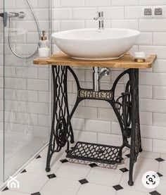 a bathroom with a sink and an old fashioned sewing machine on the counter next to it