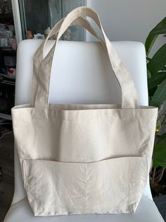 Canvas tote bag is ideal for a trip to the beach or for that quick weekend getaway!  Perfect for everyday, baby mommy bag, quick grocery trip, work bag, craft project bag, or can be used as a gift bag or for your bridal party. Natural textured canvas with 2 large exterior pockets and long comfortable double handles. Measurements: Body (w x h x d): 28 x 30.5 x 12 cm (11 x 12 x 4.75 in.) Handle drop: 30.5 cm (12 in.) If you have any queries, please leave a message. Thank you for visiting us. Eco-friendly On-the-go Bags With Pockets, Eco-friendly Large Capacity Canvas Bag For On-the-go, Large Natural Canvas Bag For Everyday Use, Large Capacity Beige Diaper Bag For Daily Use, Everyday Natural Beach Bag With Removable Pouch, Large Capacity Beige Rectangular Diaper Bag, Large Capacity Rectangular Beige Diaper Bag, Beige Shoulder Diaper Bag For Daily Use, Beige Large Capacity Rectangular Diaper Bag