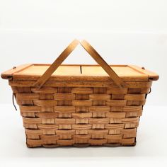 a wooden basket sitting on top of a white table