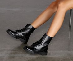 Bring the edge! These boots feature a lace up detail with metal eyelets. a functioning side zipper. and a round toe. They have a rubber lug sole and are composed of a faux leather material.