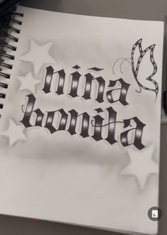 an open spiral notebook with the word annna written in cursive writing