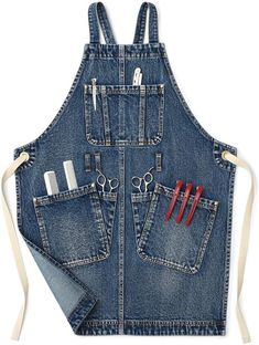 a denim apron with scissors and other tools in the pocket, on a white background