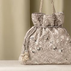 Silver Zardozi Sequin Flower Embroidered Satin Gray Wedding Potli Bag for Woman | Evening Cocktail Luxury Handcrafted Drawstring Purse Bag Size  : 10 x 8 Inches Package Content : 1 Pcs Designed with the heart, this beautiful Potli or batawa bag are eye catchy and made of premium material. Key Features: Embroidery art work This potli is good match with both Indian and western outfits and are superb for wedding and festive parties This would be best complement to your designer saree, lenhga or any other kind of dress This is the combination of traditional and modern embroidery work This is enough to keep your accessories and all needed essentials and it can be a best gift for any woman. Silver Embroidered Bags Suitable For Gifts, Silver Embroidered Bag For Gift, Silver Embroidered Bags As Gift, Festive Embellished Pouch Bag, Evening Bags With Floral Embroidery For Festivals, Embellished Pouch Bag For Reception, Floral Embroidered Bags For Festivals And Receptions, Elegant Handheld Embroidered Pouch, Floral Embroidered Bags For Receptions And Festivals