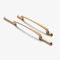 two gold metal handles on a white background, one is open and the other is closed