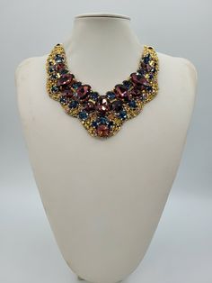 Each piece of our statement necklaces is handmade and one of a kind made in Italy. Our creations is made of high quality materials such as crystals and rhinestones. Each embroidered material is carefully hand sewn. Very glamorous and stylish. Perfect gift to someone you like. Materials Strass stone and Rhinestone in Burgungy and Montana color in different dimension.  Black satin fabric backing. Aluminium chain with lobster closure. Measurements Weight approximate 200 grams. Chain lenght 25 cm - 9.84 in Circumference approximate 63 cm - 24.80 in Feel free to contact us if you have any question. Thank you so much for looking at our shop and our articles each of them, single piece. Luxury Choker Necklace For Party, Luxury Party Choker Necklace, Luxury Handmade Beaded Necklaces For Party, Handmade Luxury Beaded Necklace For Parties, Luxury Handmade Beaded Necklace For Party, Luxury Handmade Beaded Party Necklace, Luxury Handmade Necklace For Party, Elegant Multicolor Rhinestone Necklace For Gift, Handmade Formal Choker Necklace