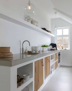 a white kitchen with wooden cabinetry and counter tops on instagram for interior design