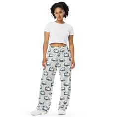 Upgrade your loungewear with our All-Over-Print Unisex Wide-Leg Pants, designed for ultimate comfort and style. These best-selling pants effortlessly blend fashion with function, making them perfect for everything from cozy pajamas to trendy streetwear. Whether you're lounging at home or stepping out, their super soft, stretchy fabric ensures comfort in every move. Crafted with premium knit mid-weight jersey fabric, these pants feature a relaxed unisex fit and an adjustable elastic waistband with a white drawstring for added comfort. Plus, the practical side pockets make them ideal for daily wear. Choose to wear them on the waist or hips for a customizable fit. The fabric's OEKO-TEX 100 standard certification guarantees safe, eco-friendly material that's gentle on the skin. Whether you're Casual Sleep Pants, Casual Sleepwear Straight Pants For Pajama Party, Casual Sleepwear Trousers With Elastic Waistband, Casual Sleep Pants With Pockets, Casual Sleep Pants With Elastic Waistband, Casual Relaxed Fit Sleep Pants, Sleepwear Trousers With Pockets For Loungewear, Trousers Sleepwear With Pockets For Loungewear, Casual Sleepwear With Relaxed Fit Trousers