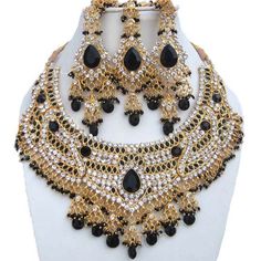 "Finekraft Zircon choker necklace Bollywood jewelry pearl jewelry design Necklace Set Earrings Birthday gift Wedding Anniversary party Introducing our stunning Kundan zircon choker necklace jewellery set, handcrafted with intricate attention to detail. This elegant piece features sparkling kundan stones set in a gold-plated base, giving it a regal and luxurious look. The choker is paired with matching earrings and a tikka headpiece, completing the traditional Indian bridal ensemble. This set is perfect for special occasions such as weddings, engagements, and other formal events. It can also be dressed down for a more casual, bohemian look. The choker is adjustable to fit a range of neck sizes, making it a versatile addition to any jewelry collection. Treat yourself or a loved one to this t Pearl Jewelry Design Necklace, Heart Packaging, Tikka Jewelry, Heavy Necklace, Indian Choker Necklace, Jewelry Kundan, Indian Bridal Jewellery, Crystals Necklace, Gray Necklace