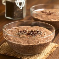 two bowls filled with oatmeal on top of a wooden table