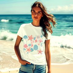 Embrace the summer vibes with our aesthetic seashell shirt, perfect for any beach lover! This stylish tee is the ultimate addition to your vacation wardrobe, capturing the essence of sun, sand, and sea. Make every day feel like a beach day with our beautifully designed summer shirt. ABOUT OUR Aesthetic Seashell Summer Shirt -Unisex T-shirt -Made with soft cotton. -Cozy shirt for ultimate comfort. -High quality print that you'll love. -AI-generated art. -The relaxed fit makes it an excellent choice for daily wear. -These t-shirts feature ribbed knit collars to enhance their shape. - Dual side seams maintain the garment's shape for a longer time. - Please note that the colors shown in the photos may vary slightly when printed. - Printed and shipped from the USA. CARE INSTRUCTIONS: -Machine w Beachy Shirt For Summer Beach Party, Beachy Vacation Shirt, Summer Shirt For Beach Party, White Beachwear Shirt For Beach, Beachy Shirt For Beach Party, Trendy Beach Vacation Shirt, Casual Ocean Color Beach Tops, Casual Ocean Color Tops For Beach, Beachy White Beach Shirt