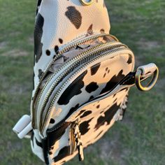 Two compartments, multiple pockets, and an adjustable strap for extra comfort. Faux leather. Dimensions: 7.5"L x 3"W x 13"H John 15 5, Bag Pack, Bagpack, Cow Print, Sling Bag, Adjustable Straps, Cow, Faux Leather, Leather